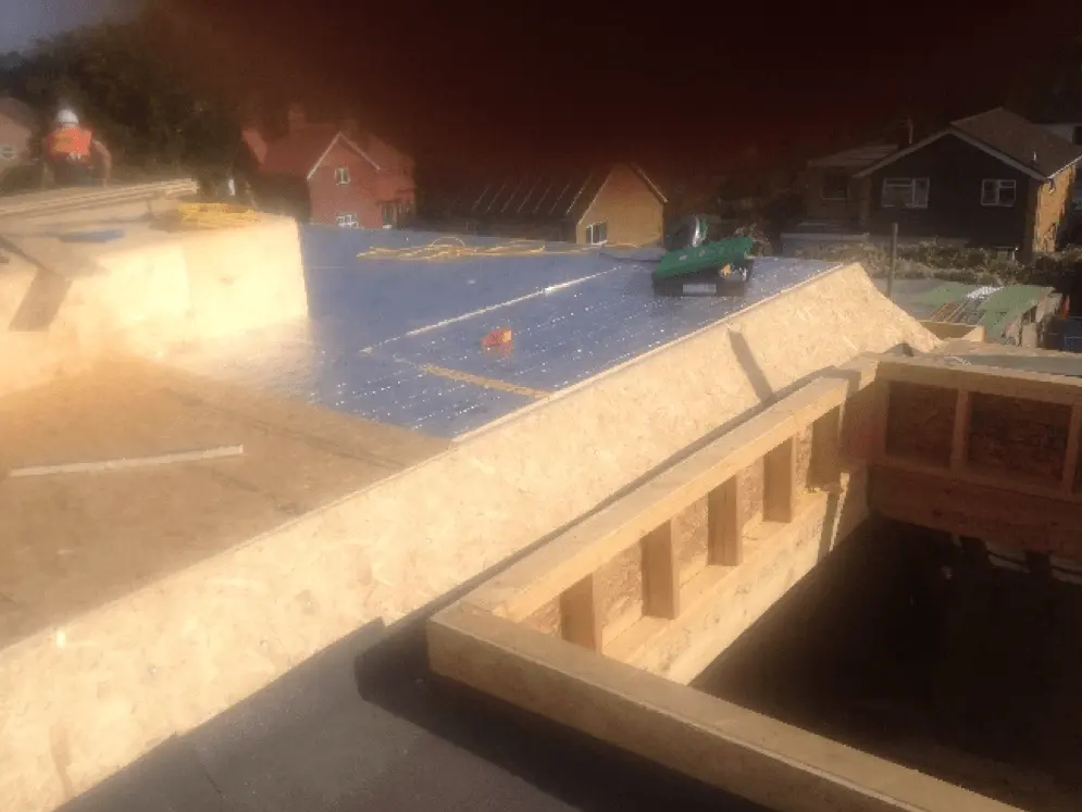 Flat roof stripped back to the timber frame around a rooflight opening