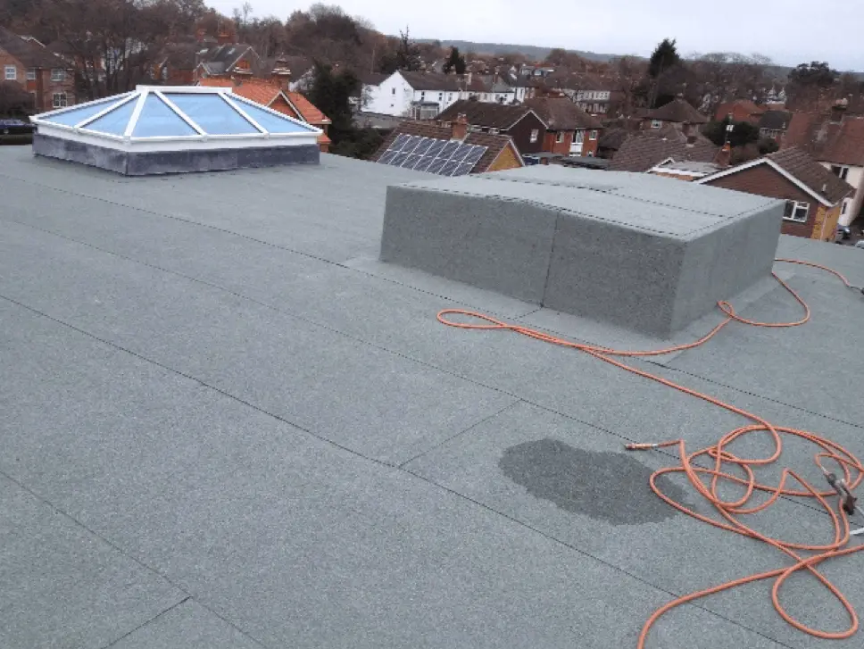 Grey flat roof with a roof lantern and vents